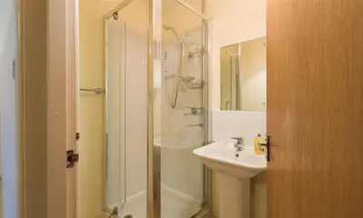 a bathroom with a shower and a sink at Grange Fell Borrowdale in Keswick