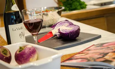 a plate of cabbage and a glass of wine on a counter at Oakbank in Elterwater