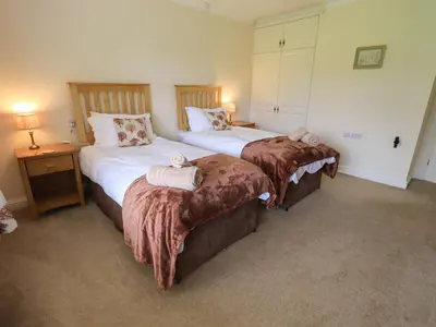 a bedroom with two beds with towels on them at Laal Field House in Keswick