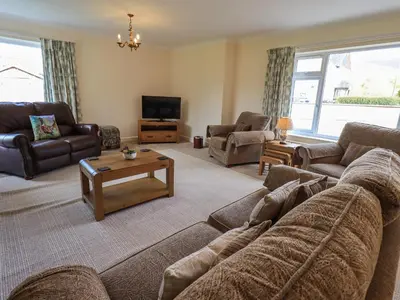 a living room with a couch and a tv at Laal Field House in Keswick