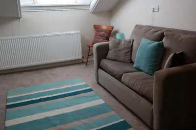 a living room with a couch and a chair at Arrandale Apartments in Douglas