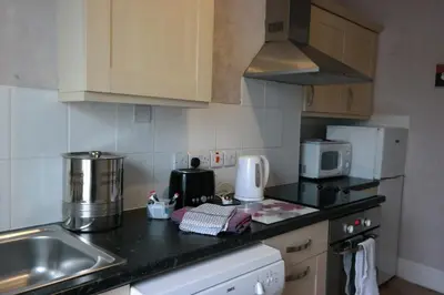 a kitchen with a sink and a counter top at Arrandale Apartments in Douglas