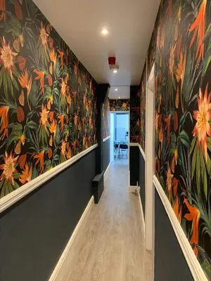 a hallway with a flower mural on the walls at Arrandale Apartments in Douglas