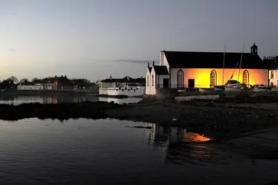 a church next to a body of water at The Steam Packet Inn in Isle of Whithorn
