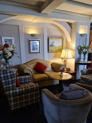 a living room with couches and a table at Balcary Bay Country House Hotel in Auchencairn