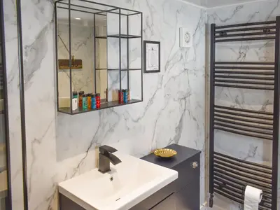 a white bathroom with a sink and a mirror at Ludlow Bank in Coulderton