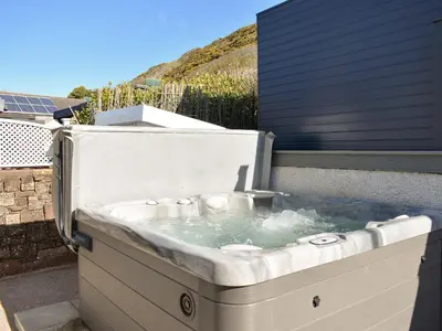 a hot tub with water in it on a patio at Ludlow Bank in Coulderton