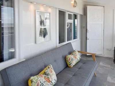 a gray couch in a living room with windows at Ludlow Bank in Coulderton