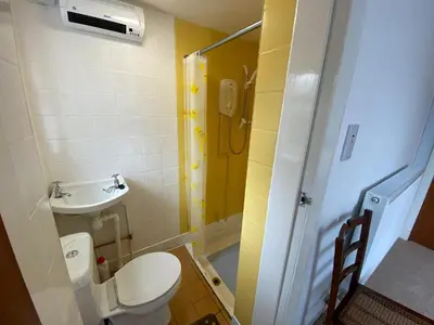 a small bathroom with a toilet and a sink at Craignair in Port William