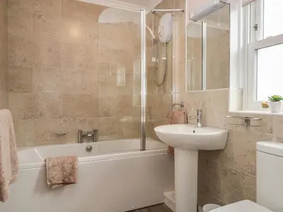a bathroom with a sink and a tub and a toilet at The Crook in Penrith