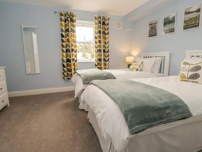 a bedroom with two beds and a window at The Crook in Penrith