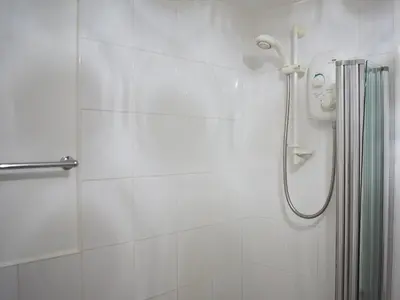 a shower with a face drawn on the wall at Eskin Den in Keswick