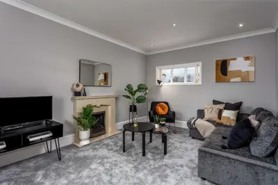 a living room with a couch and a tv at Sunset View - Donnini Apartments in Ayr