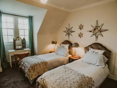 two beds in a room with stars on the wall at Fern Forest House- Uk31047 in Portpatrick