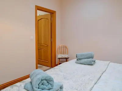a bedroom with a bed with blue towels on it at Laird House in Lochmaben