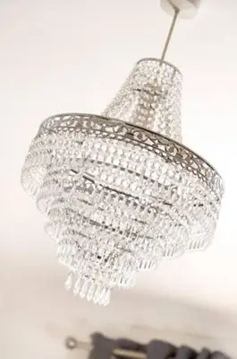 a silver chandelier hanging from a ceiling at Four Oaks Cottage in Rockcliffe