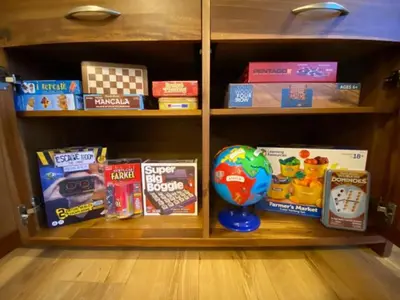 a book shelf filled with lots of toys and games at Four Oaks Cottage in Rockcliffe
