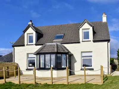 a house with a gazebo in front of it at Loanmhor in Kilmory