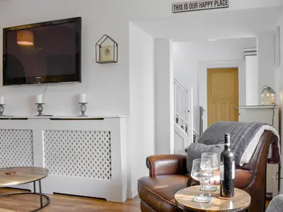 a living room with a couch and a television at Loanmhor in Kilmory
