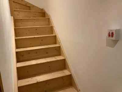 a stairwell with wooden steps in a room at Dove Cottage (Annex) in Workington