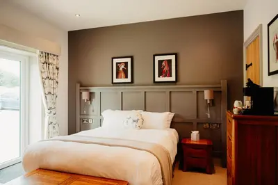 a bedroom with a large white bed and a window at The Fleece at Ruleholme in Carlisle