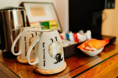 a couple of coffee mugs sitting on top of a counter at The Fleece at Ruleholme in Carlisle