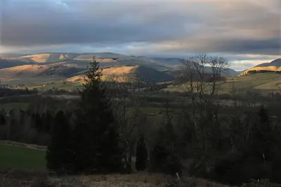 a view of a field with mountains in the background at The Green House at Tathhill in Beattock