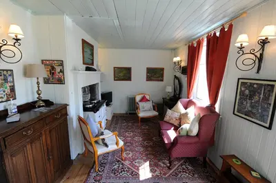 a living room with two chairs and a desk at The Green House at Tathhill in Beattock