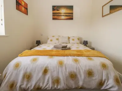 a bedroom with a bed with daisies on it at The Croft Bungalow in Wigton