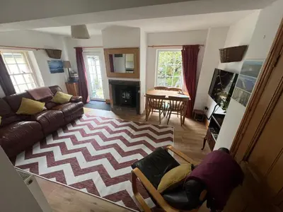 a living room with a couch and a table at Robinsons Cottage, central and quiet in Cockermouth
