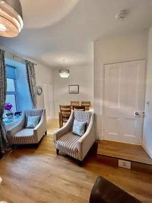 a living room with two chairs and a table at The Blue Door in Kirkcudbright