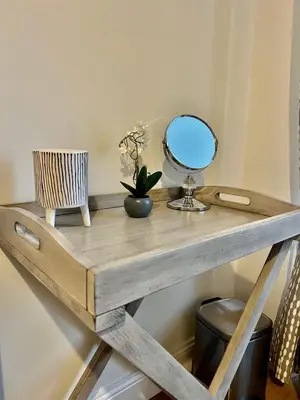 a wooden table with a mirror on top of it at The Blue Door in Kirkcudbright