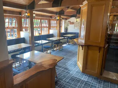 a restaurant with tables and chairs in a room at The Mill Forge Hotel in Gretna Green