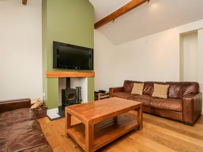 a living room with a couch and a table and a tv at Beckwood in Penrith
