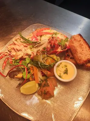 a plate of food with shrimp and vegetables on a table at The Maid's House in Lanark