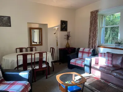a living room with a couch and a table at The Maid's House in Lanark