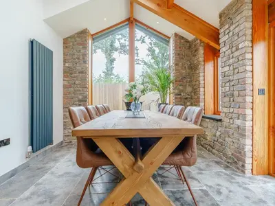 a dining room with a wooden table and leather chairs at Herdwick View - Uk33668 in Bassenthwaite Lake