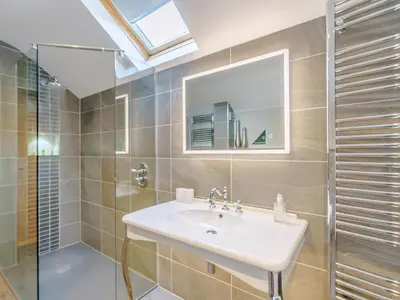 a bathroom with a sink and a shower and a mirror at Herdwick View - Uk33668 in Bassenthwaite Lake
