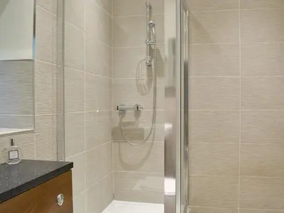 a shower with a glass door in a bathroom at The Coach House in Keswick