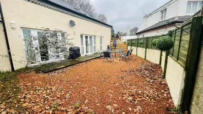 a yard with chairs and a table in a house at The Old Stables 17a in Dumfries