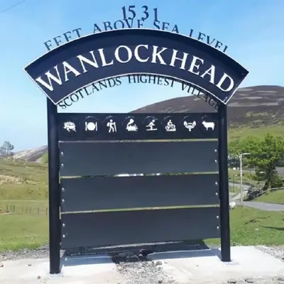 a sign for a wanlockhead sign on a road at 3 Dialknowe Holiday Cottage - Wanlockhead - 3 Bedrooms in Wanlockhead