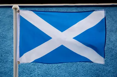 a blue and white flag on a pole at St Andrews Guest House in Irvine