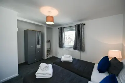 a bedroom with two beds and a window at Mews House in Ayr