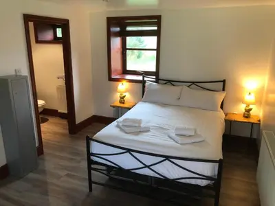 a bedroom with a bed with two towels on it at Ochiltree cottage in Newton Stewart