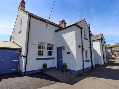 a white house with a blue door at Seascape in Annan