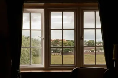 a window with four views of a field at Troon Arts & Crafts Period Home Golf Beach in Troon