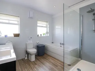 a bathroom with a tub and a toilet and a sink at Ailsa Shores in Turnberry