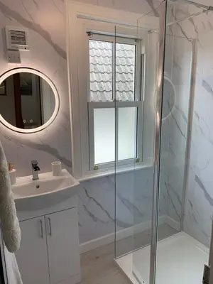 a bathroom with a shower and a sink and a mirror at 4 bedroom townhouse Kirkcudbright in Kirkcudbright