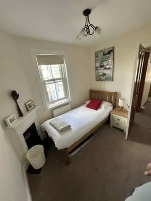 a bedroom with a large bed and a window at 4 bedroom townhouse Kirkcudbright in Kirkcudbright