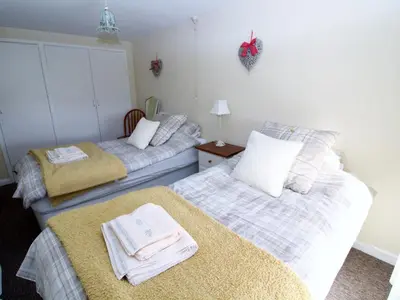 two beds in a bedroom with towels on them at 2 Mellfell View in Penrith